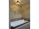 Inviting bathtub with wood trim and jacuzzi jets for relaxation and comfort in spa-like setting at 286 S Woodridge Dr, Pittsboro, IN 46167
