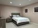 Comfortable bedroom with soft pink walls, carpet, natural light, and a cozy queen-sized bed at 286 S Woodridge Dr, Pittsboro, IN 46167
