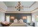 This cozy bedroom features a chandelier, decorative sconces, and a door to the outside at 286 S Woodridge Dr, Pittsboro, IN 46167