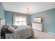 Comfortable bedroom featuring soft blue walls, plush carpet, and a white dresser at 286 S Woodridge Dr, Pittsboro, IN 46167