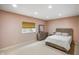 Bedroom features a neutral color palette, including a wooden bed frame and dresser at 286 S Woodridge Dr, Pittsboro, IN 46167