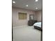 Inviting bedroom with soft pink walls, carpet, natural light, and modern gray dresser at 286 S Woodridge Dr, Pittsboro, IN 46167