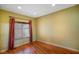 Bright bedroom features hardwood floors, recessed lighting, and window with red curtain at 286 S Woodridge Dr, Pittsboro, IN 46167