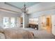 This spacious bedroom features a chandelier, TV, and doorways to the bathroom and the hallway at 286 S Woodridge Dr, Pittsboro, IN 46167
