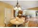 Charming dining area featuring hardwood floors, a decorative chandelier, and views into the living space at 286 S Woodridge Dr, Pittsboro, IN 46167
