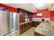 Full view of kitchen with stainless steel fridge, wood cabinets, granite countertop, and sink at 286 S Woodridge Dr, Pittsboro, IN 46167