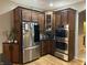 Modern kitchen with stainless steel appliances and dark wood cabinets at 286 S Woodridge Dr, Pittsboro, IN 46167