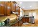 Kitchen featuring dark cabinets, granite counters, stainless steel appliances and breakfast bar at 286 S Woodridge Dr, Pittsboro, IN 46167