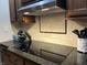 Close up shot of modern cooktop and granite countertops in kitchen at 286 S Woodridge Dr, Pittsboro, IN 46167