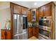 Well-appointed kitchen boasts stainless steel appliances, rich wood cabinetry, and granite countertops at 286 S Woodridge Dr, Pittsboro, IN 46167