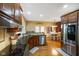 Spacious kitchen features stainless steel appliances, dark granite counters, and hardwood flooring at 286 S Woodridge Dr, Pittsboro, IN 46167