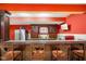 Basement kitchen features dark wood cabinets, granite countertops, and bar stool seating at 286 S Woodridge Dr, Pittsboro, IN 46167