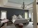 A serene main bedroom featuring a crystal chandelier, neutral color scheme, and comfortable king-sized bed at 286 S Woodridge Dr, Pittsboro, IN 46167