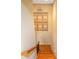 View of the hardwood staircase with white walls and unique decorations at 286 S Woodridge Dr, Pittsboro, IN 46167