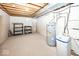 Unfinished basement featuring a water heater, water softener, and shelving providing ample storage space at 2888 Prairie Stream Way, Columbus, IN 47203
