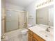 Well-lit bathroom featuring a vanity, toilet, and a shower-tub combo with glass sliding doors at 2888 Prairie Stream Way, Columbus, IN 47203