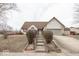 Charming home with a brick and siding exterior, landscaped front yard, and inviting entryway steps at 2888 Prairie Stream Way, Columbus, IN 47203