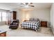 Bedroom with a large armchair, side tables, and neutral decor at 3229 Autumn Ash Dr, Zionsville, IN 46077
