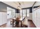 Dining room featuring dark accent walls, white trim, bench seating and modern chandelier at 3229 Autumn Ash Dr, Zionsville, IN 46077