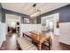Open dining room with dark accent walls, white trim, bench seating, and view to living room at 3229 Autumn Ash Dr, Zionsville, IN 46077