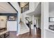Bright foyer with wood floors, staircase, and wainscoting, showcasing a welcoming entrance at 3229 Autumn Ash Dr, Zionsville, IN 46077