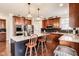 Spacious kitchen with stainless steel appliances, wooden cabinets, and a center island with seating at 3229 Autumn Ash Dr, Zionsville, IN 46077