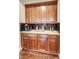 Coffee bar with wood cabinets, black tile backsplash, and decorative countertop accessories at 3229 Autumn Ash Dr, Zionsville, IN 46077