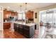 Open concept kitchen with stainless steel appliances, wood cabinets, and a large island with seating at 3229 Autumn Ash Dr, Zionsville, IN 46077