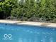 Inviting pool with well-maintained landscaping, offering a serene backyard oasis for relaxation and entertainment at 3229 Autumn Ash Dr, Zionsville, IN 46077