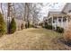 Spacious backyard featuring a well-maintained lawn, a wood fence, and manicured shrubs and trees at 3560 Cardinal Way, Carmel, IN 46074