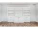 Finished basement boasts large built-in entertainment center with white cabinets at 3560 Cardinal Way, Carmel, IN 46074