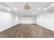 Spacious finished basement with wood floors, built-in shelving, and modern lighting at 3560 Cardinal Way, Carmel, IN 46074