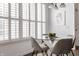 Bright dining area with large windows, modern lighting, and a stylish glass table at 3560 Cardinal Way, Carmel, IN 46074