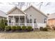 Home's exterior features a screened porch, a deck, well-maintained bushes, and a manicured lawn at 3560 Cardinal Way, Carmel, IN 46074