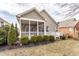Exterior view featuring a screened porch, a deck, well-maintained bushes, and a lawn at 3560 Cardinal Way, Carmel, IN 46074