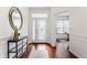 Inviting front foyer features gleaming hardwood floors, transom windows, and elegant console table at 3560 Cardinal Way, Carmel, IN 46074