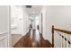 Bright hallway with hardwood floors and detailed molding leading to bedrooms and living areas at 3560 Cardinal Way, Carmel, IN 46074