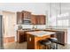 Modern kitchen with custom wood cabinets, a central island with seating, and stainless steel appliances at 3560 Cardinal Way, Carmel, IN 46074