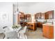 Bright kitchen and dining area featuring custom wood cabinetry, island seating, and modern appliances at 3560 Cardinal Way, Carmel, IN 46074
