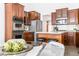 Spacious kitchen with island seating, custom cabinetry, stainless appliances, and a view to the dining area at 3560 Cardinal Way, Carmel, IN 46074
