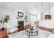 Cozy living room features a fireplace, hardwood floors, and natural light for relaxation at 3560 Cardinal Way, Carmel, IN 46074
