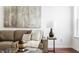 Cozy living room featuring a comfortable brown sofa, modern art, and stylish decor elements at 3560 Cardinal Way, Carmel, IN 46074