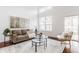 Sun-filled living room with vaulted ceilings, hardwood floors, and sliding doors offering outdoor access at 3560 Cardinal Way, Carmel, IN 46074