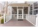 View of the screened in porch with a brown deck and white railing leading to a glass door at 3560 Cardinal Way, Carmel, IN 46074
