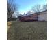 Fenced backyard features a spacious lawn, patio, and a convenient storage shed at 3841 Monica Ct, Indianapolis, IN 46226