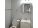 Bathroom featuring a toilet, a sink with vanity, and mirror over the sink with towel and toilet paper holders at 3841 Monica Ct, Indianapolis, IN 46226