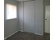 Neutral-toned bedroom featuring a window for natural light and a spacious closet for storage at 3841 Monica Ct, Indianapolis, IN 46226