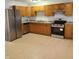 Spacious kitchen featuring stainless steel appliances, granite countertops, and oak cabinetry at 3841 Monica Ct, Indianapolis, IN 46226