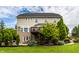 Spacious backyard with a deck, mature landscaping, and a partial view of the home's exterior at 3905 Pelham Rd, Carmel, IN 46074
