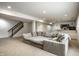 Finished basement boasts a large sectional sofa, wet bar, and convenient stair access at 3905 Pelham Rd, Carmel, IN 46074